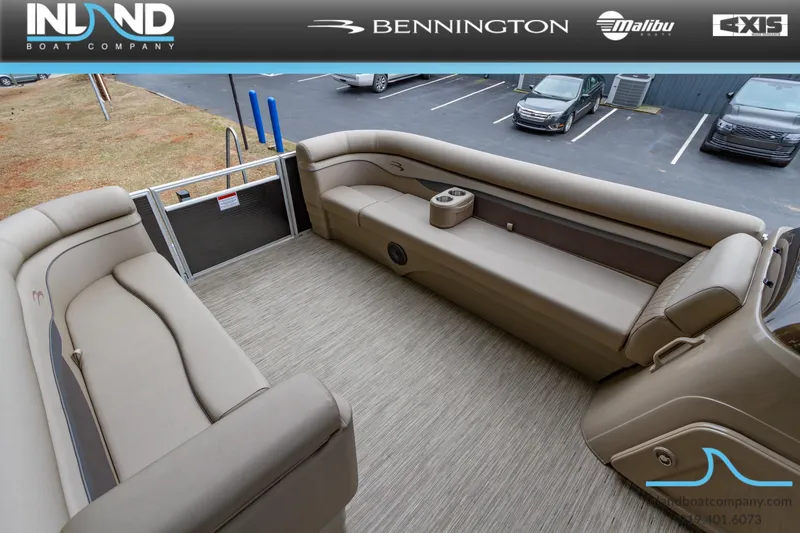 Slide: The Image of 2023 Bennington 22 SL pontoon boat interior with beige seating and carpet. - 21