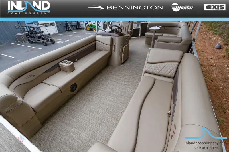 Slide: The Image of 2023 Bennington 22 SL pontoon boat interior with beige seating, displayed at Inland Boat Company. - 22