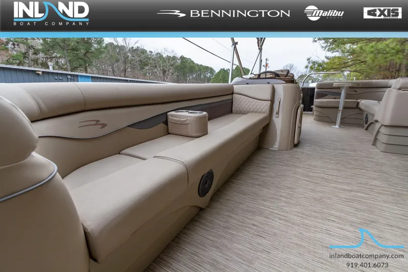 Slide: The Image of 2023 Bennington 22 SL pontoon boat interior with beige seating and carpet. - 7