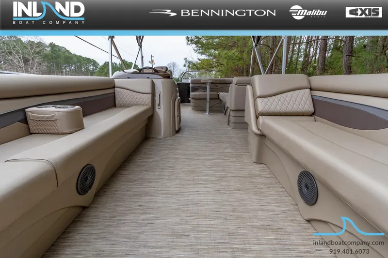Slide: The Image of 2023 Bennington 22 SL pontoon boat interior with beige seating and spacious layout. - 8