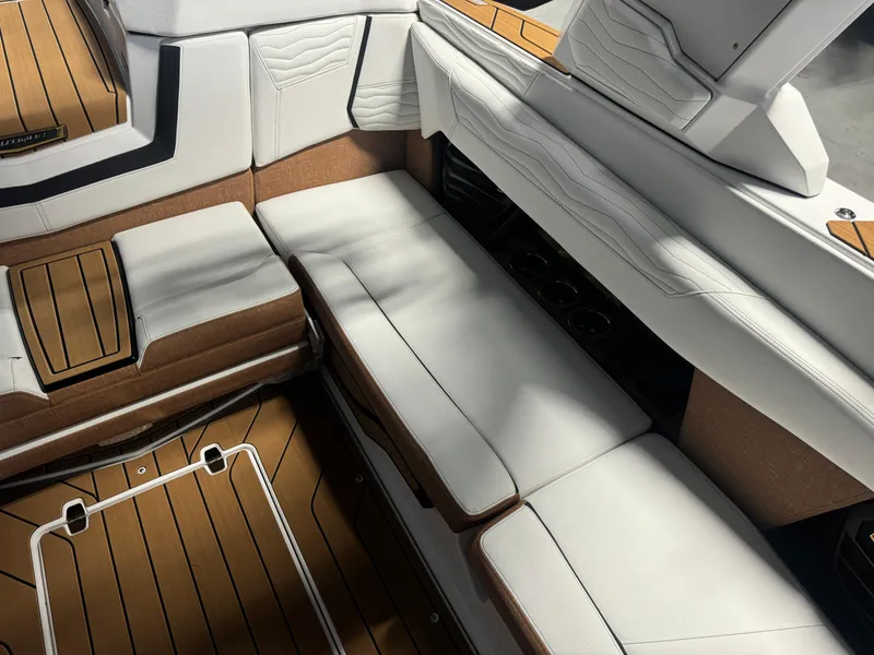 Slide: The Image of 2025 Nautique Super Air G23 interior with white and brown seating and sleek design. - 10