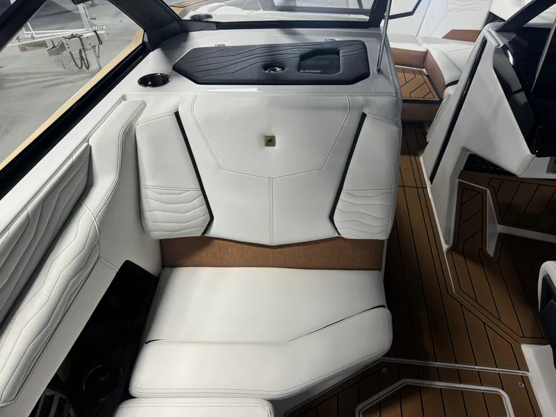 Slide: The Image of 2025 Nautique Super Air G23 interior with white leather seating and wood accents. - 11