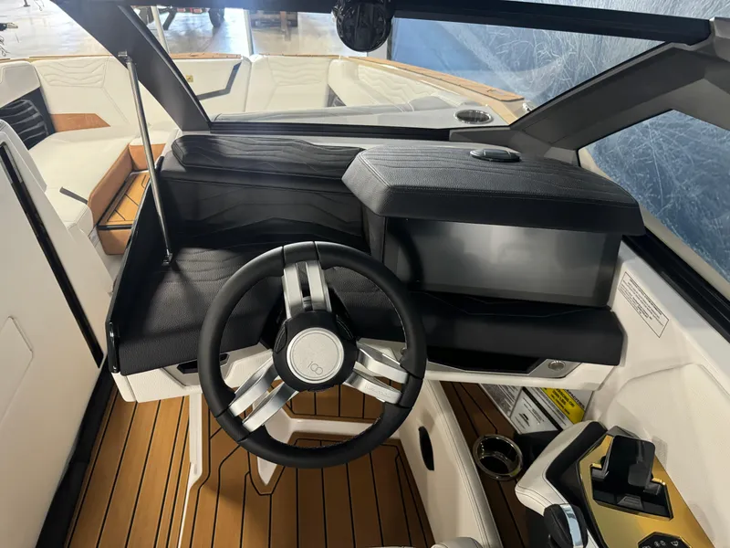 Slide: The Image of 2025 Nautique Super Air G23 boat cockpit with modern steering and dashboard design. - 12
