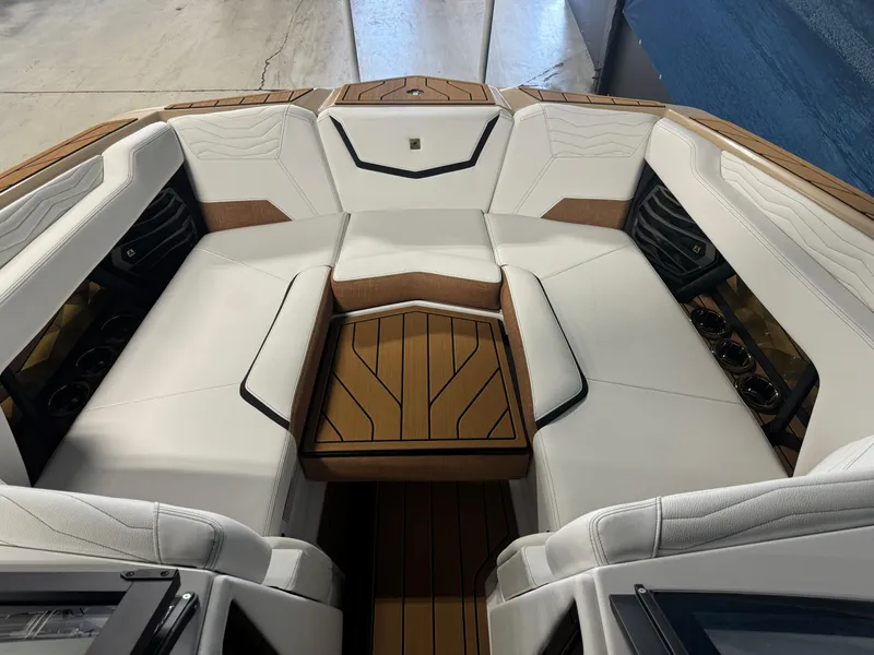 Slide: The Image of 2025 Nautique Super Air G23 boat interior with luxurious white seating and teak flooring. - 15