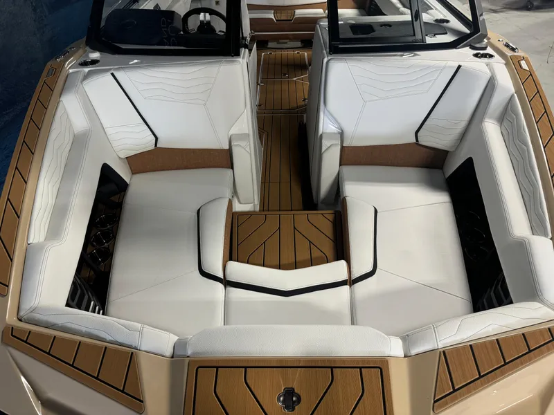 Slide: The Image of 2025 Nautique Super Air G23 boat interior with white and brown seating. - 16