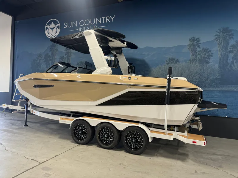 Slide: The Image of 2025 Nautique Super Air G23 boat on a trailer at Sun Country Inland showroom. - 3