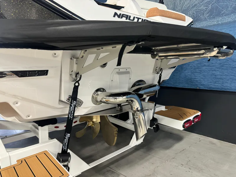 Slide: The Image of 2025 Nautique Super Air G23 boat stern with propeller and exhaust system. - 4