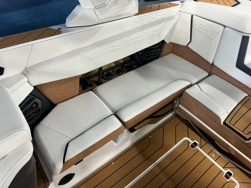 Slide: The Image of 2025 Nautique Super Air G23 interior with white and brown seating, showcasing luxury design. - 8