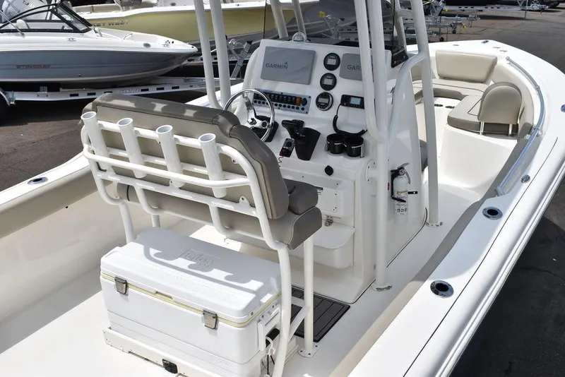 Slide: The Image of 2022 Key West 239FS boat interior with helm, seating, and cooler. - 11