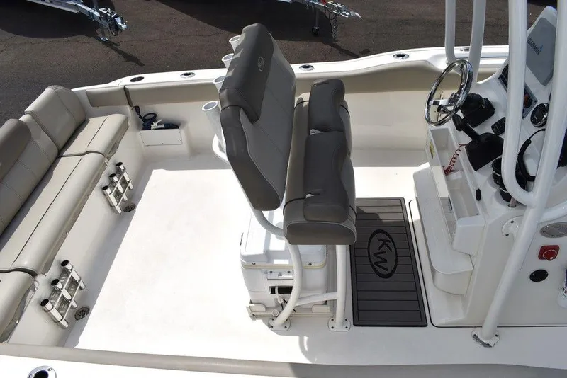 Slide: The Image of 2022 Key West 239FS boat interior with seating and steering console. - 13