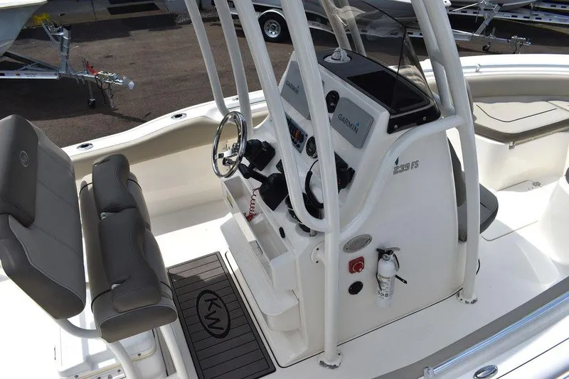 Slide: The Image of 2022 Key West 239FS boat interior with steering console and seating. - 14
