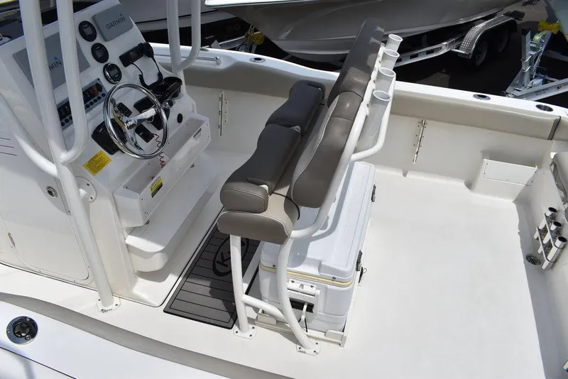 Slide: The Image of 2022 Key West 239FS boat interior with helm, seating, and console. - 19