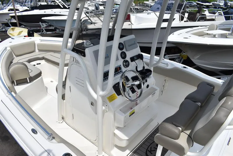 Slide: The Image of 2022 Key West 239FS boat interior with steering console and seating. - 20