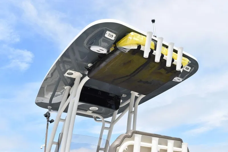 Slide: The Image of 2022 Key West 239FS boat T-top with rod holders against blue sky. - 22