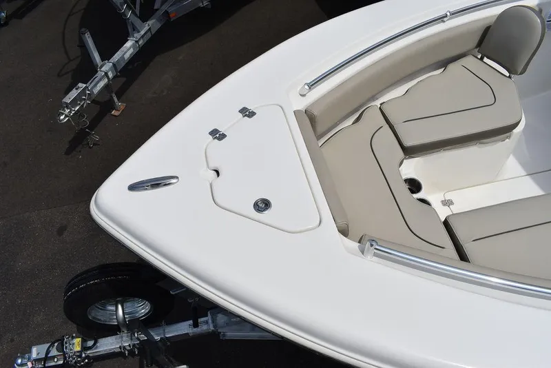 Slide: The Image of 2022 Key West 239FS boat bow with cushioned seating and trailer. - 27