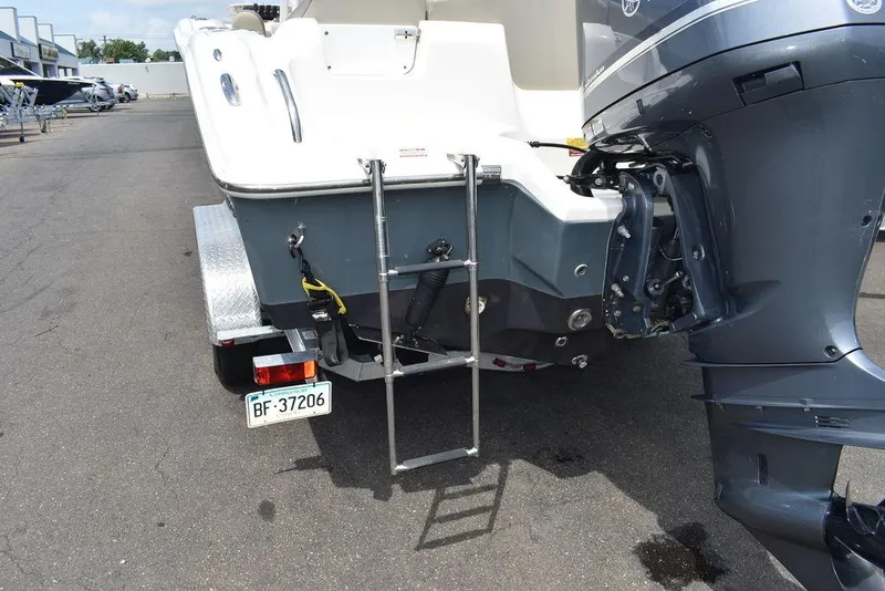 Slide: The Image of 2022 Key West 239FS boat with ladder and outboard motor on trailer. - 28
