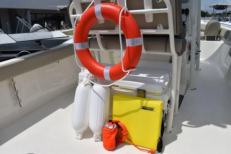 Slide: The Image of 2022 Key West 239FS boat with safety equipment, including life ring and fenders. - 35