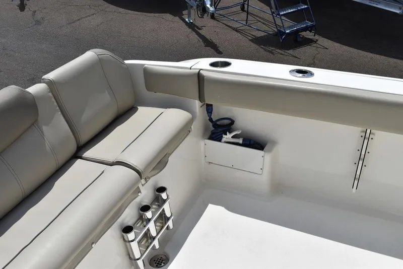 Slide: The Image of 2022 Key West 239FS boat interior with beige seating and cup holders. - 36