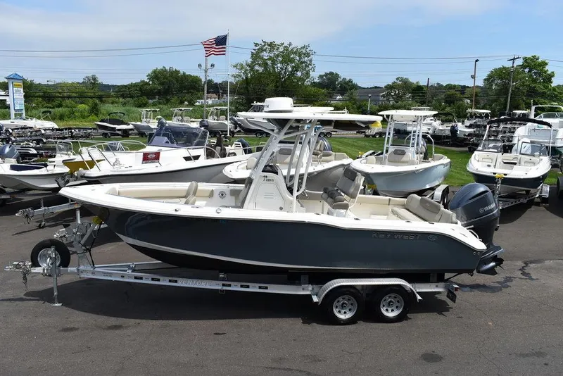 Slide: The Image of 2022 Key West 239FS boat on trailer in marina, surrounded by other boats. - 4