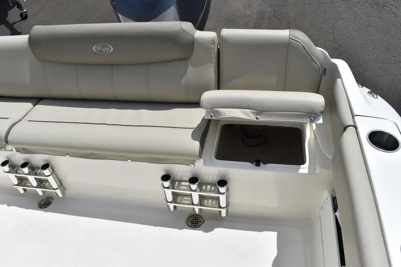 Slide: The Image of 2022 Key West 239FS boat seating area with rod holders and storage compartment. - 41