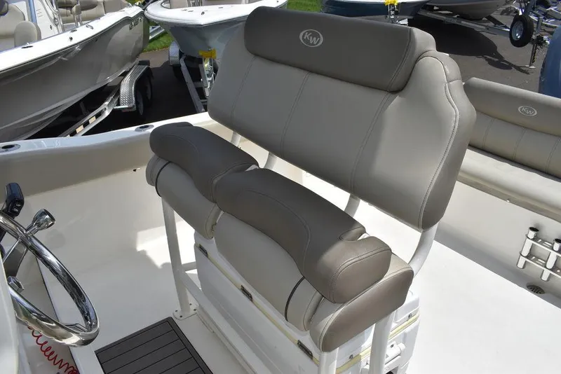 Slide: The Image of 2022 Key West 239FS boat seating with cushioned helm seats. - 42