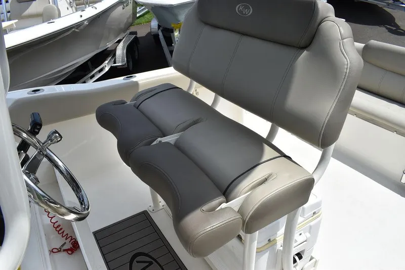 Slide: The Image of 2022 Key West 239FS boat seating with steering wheel, gray upholstery. - 43