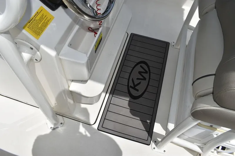 Slide: The Image of Key West 239FS 2022 boat interior with KW logo mat and seating. - 44