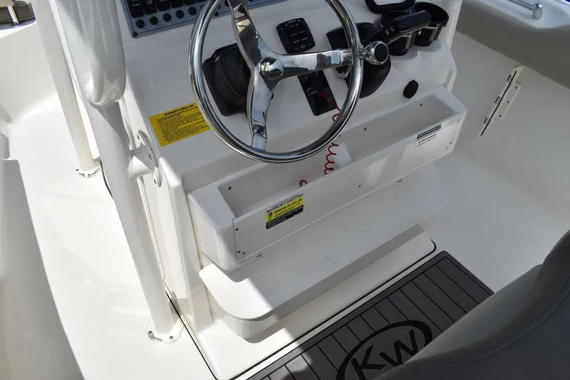 Slide: The Image of 2022 Key West 239FS boat steering console with chrome wheel and control panel. - 45