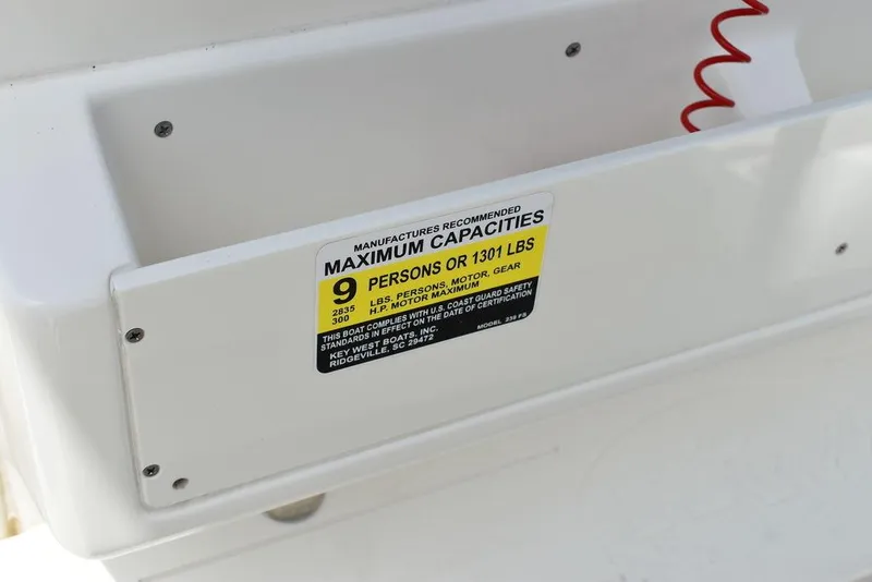 Slide: The Image of Key West 239FS 2022 boat capacity label, maximum 9 persons or 1301 lbs. - 46