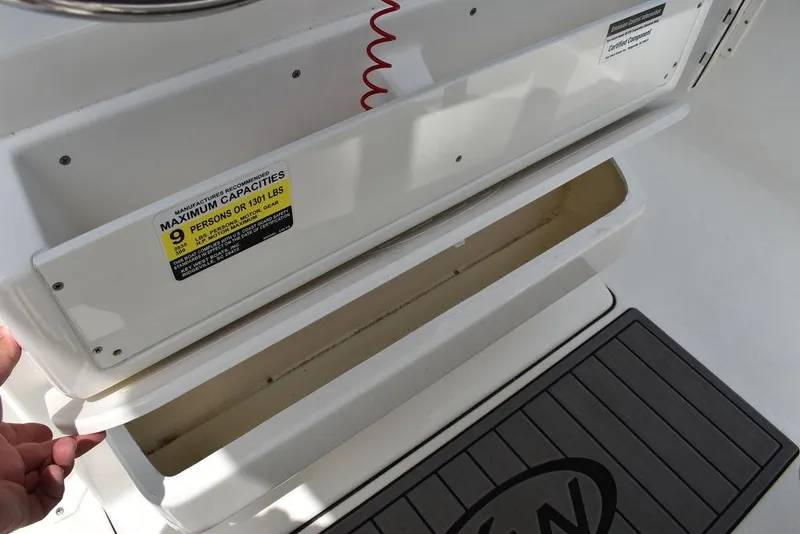 Slide: The Image of Key West 239FS 2022 boat storage compartment with capacity label. - 47