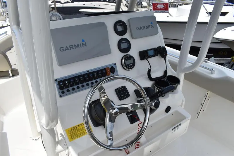 Slide: The Image of 2022 Key West 239FS boat dashboard with Garmin navigation system and steering wheel. - 48