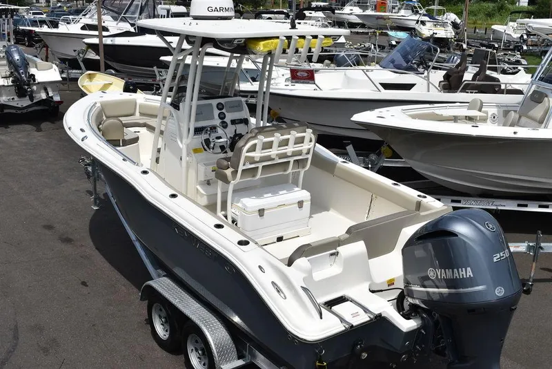 Slide: The Image of 2022 Key West 239FS boat with Yamaha engine, parked on trailer in marina. - 6