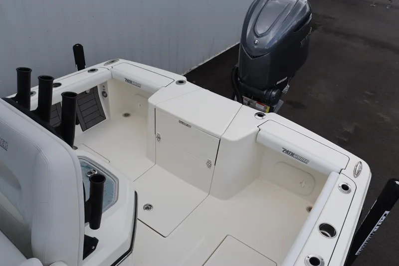 Slide: The Image of 2024 Pathfinder 2400 Open boat deck with storage compartments and outboard motor. - 11