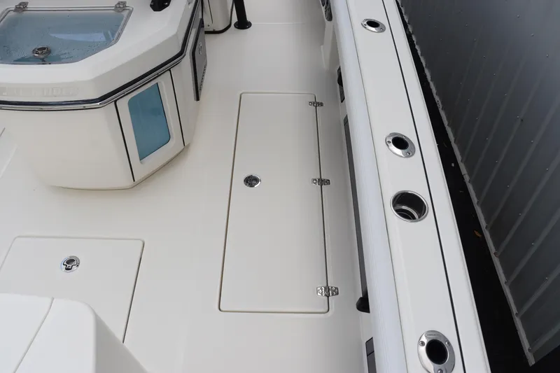 Slide: The Image of 2024 Pathfinder 2400 Open boat deck with storage compartments and rod holders. - 14