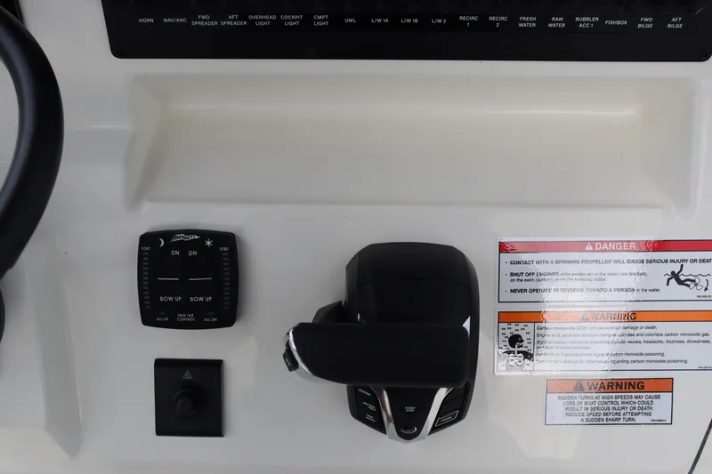 Slide: The Image of Control panel of 2024 Pathfinder 2400 Open boat with throttle and warning labels. - 22