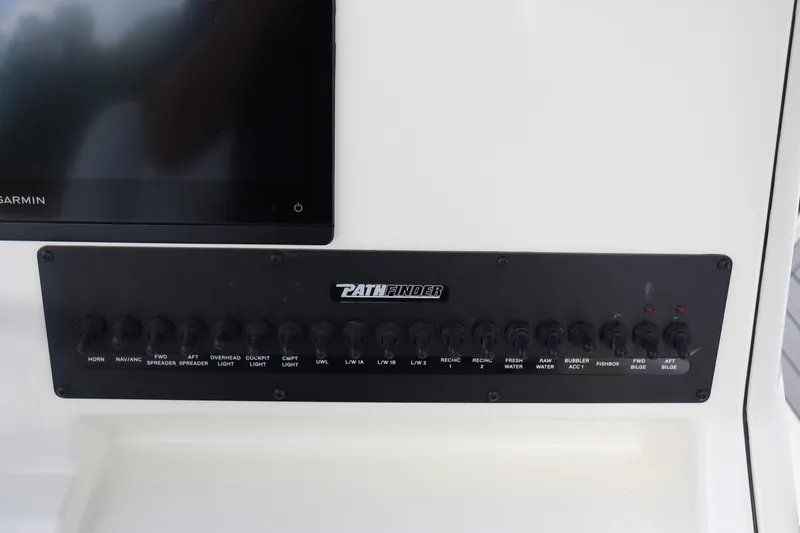Slide: The Image of Control panel of 2024 Pathfinder 2400 Open boat with labeled switches. - 23