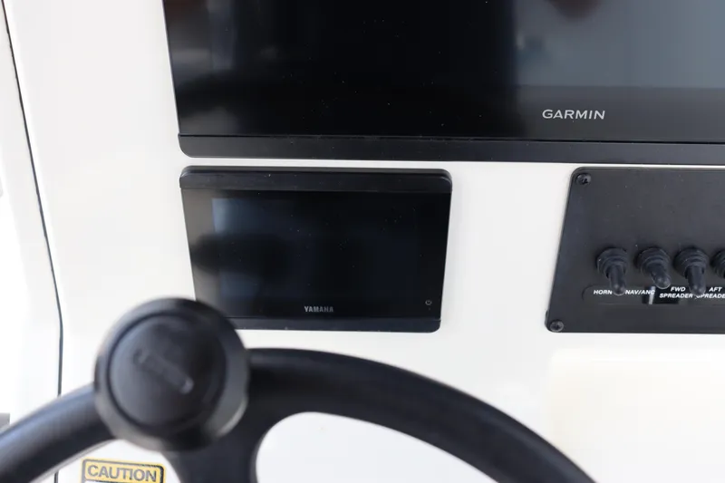 Slide: The Image of Dashboard of 2024 Pathfinder 2400 Open boat with Garmin and Yamaha displays. - 24