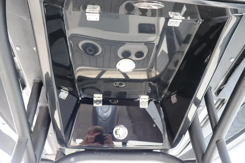 Slide: The Image of 2024 Pathfinder 2400 Open boat storage compartment with reflective black interior. - 25