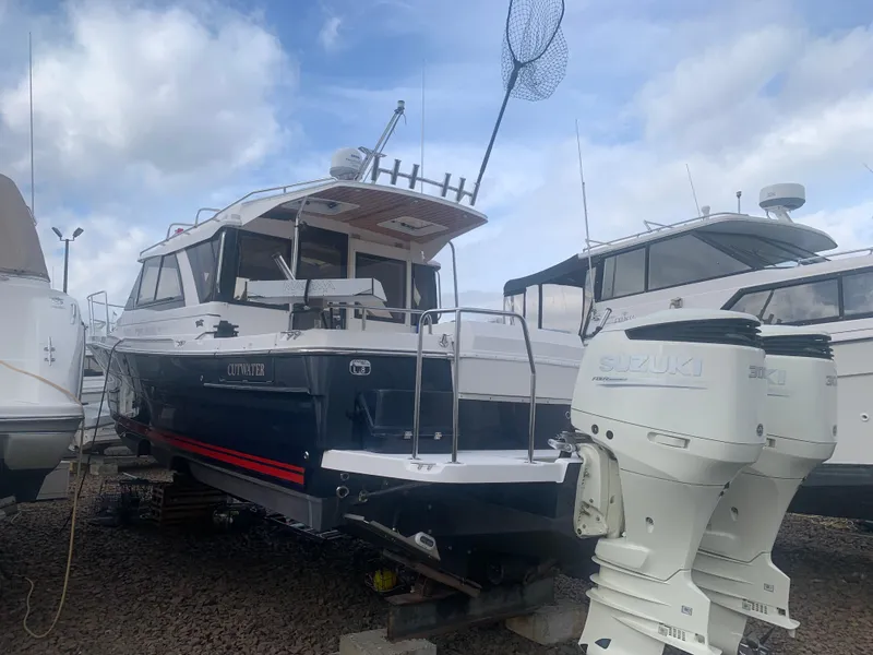 The Image of 2018 Cutwater C 302 Coupe boat on dry dock with twin Suzuki outboard engines. - 0