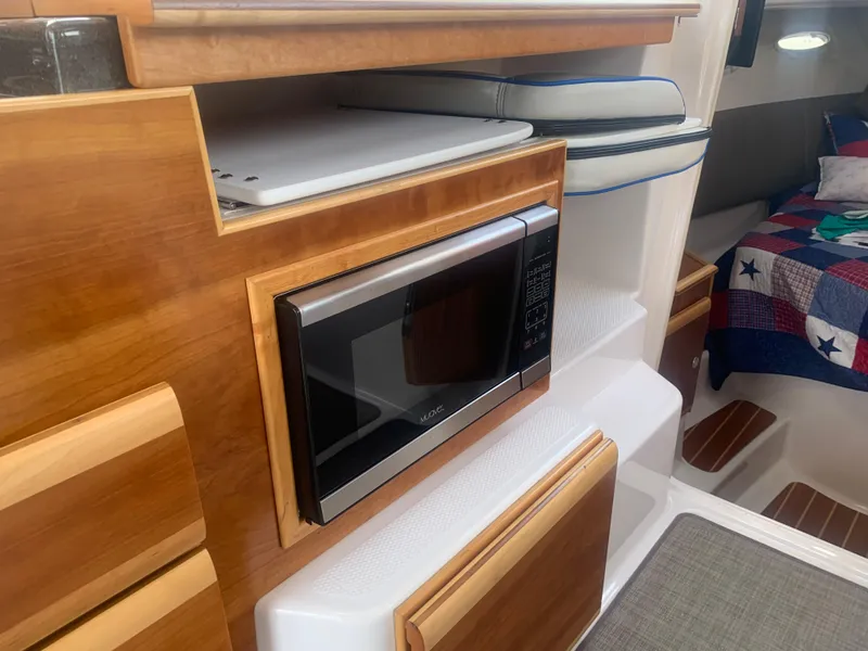 Slide: The Image of 2018 Cutwater C 302 Coupe interior with microwave and cozy cabin. - 10