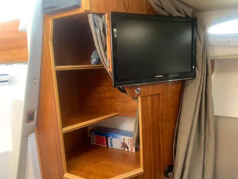 Slide: The Image of 2018 Cutwater C 302 Coupe interior with TV and wooden shelves. - 14