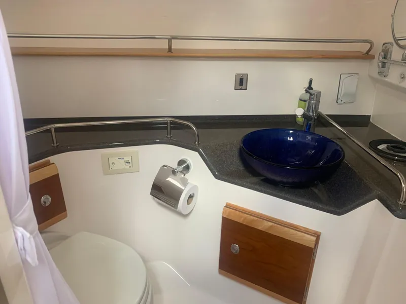 Slide: The Image of 2018 Cutwater C 302 Coupe bathroom with modern sink and toilet. - 15