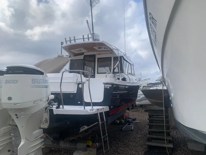 Slide: The Image of 2018 Cutwater C 302 Coupe boat on dry dock with Suzuki outboard engines. - 2