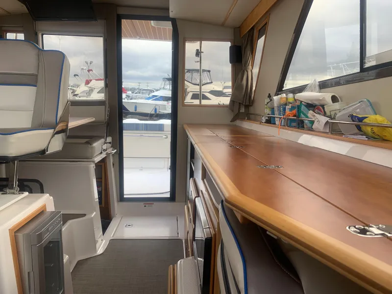 Slide: The Image of Interior of 2018 Cutwater C 302 Coupe boat with wooden countertops and seating. - 5