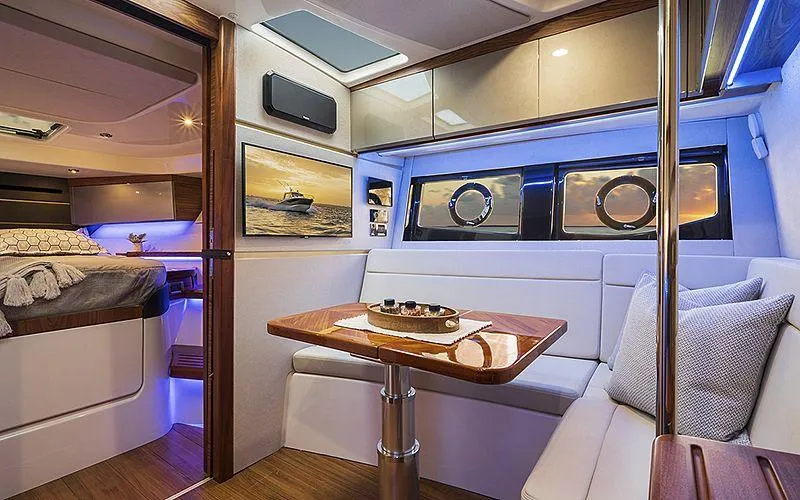 Slide: The Image of Luxurious interior of 2021 Boston Whaler 405 Conquest yacht with dining area and cozy seating. - 15