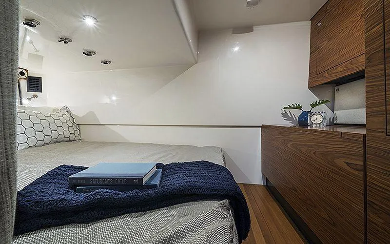 Slide: The Image of Luxurious cabin interior of 2021 Boston Whaler 405 Conquest with cozy bed and wooden cabinetry. - 16