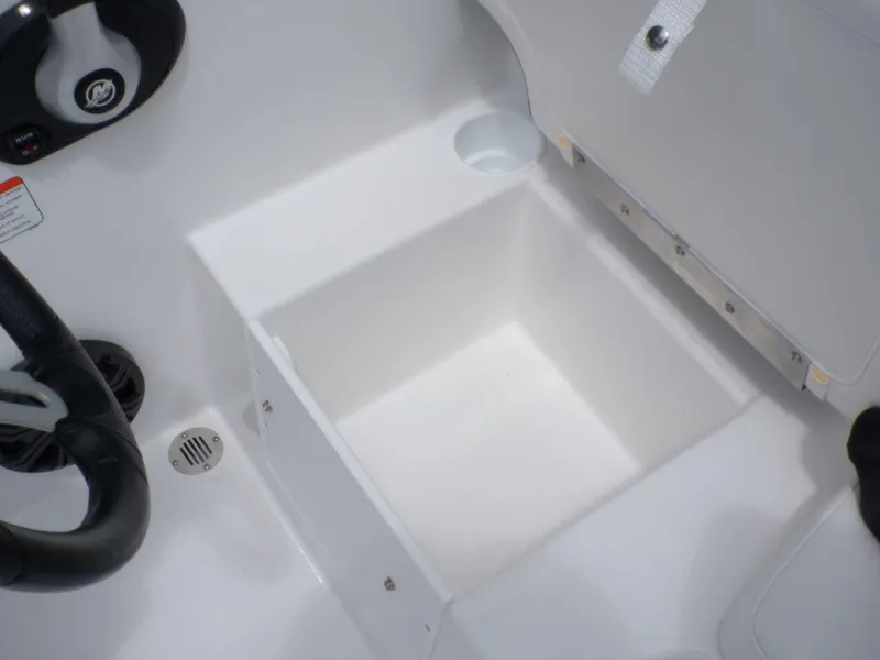Slide: The Image of 2024 Tahoe T16 boat storage compartment with cup holder and steering wheel detail. - 13