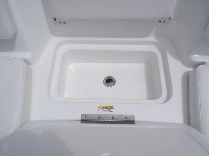 Slide: The Image of 2024 Tahoe T16 boat interior with built-in storage compartment and drain. - 15