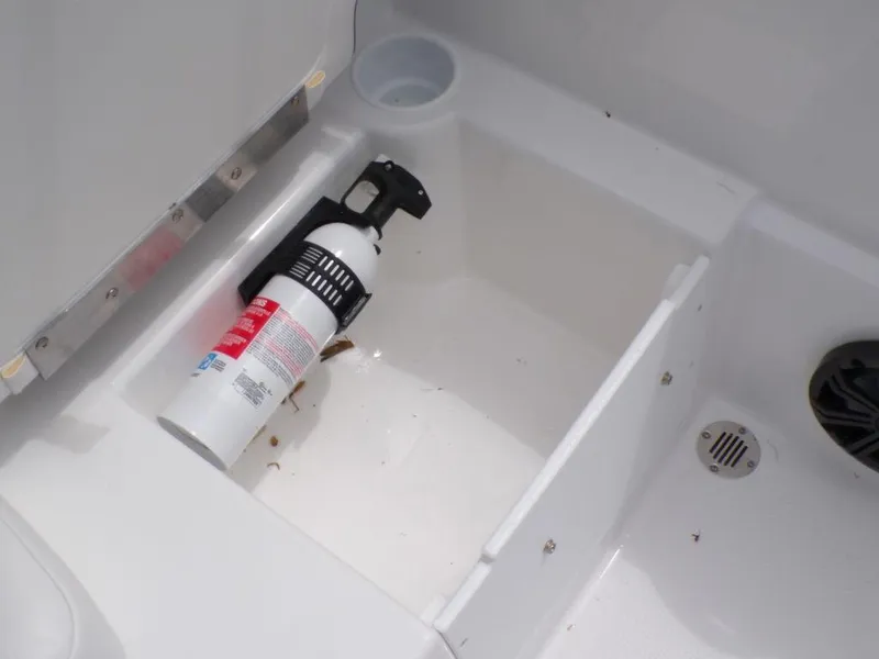Slide: The Image of Fire extinguisher in 2024 Tahoe T16 boat storage compartment. - 16
