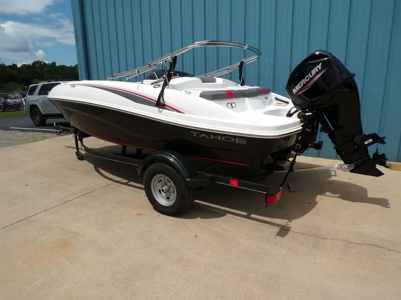 Slide: The Image of 2024 Tahoe T16 boat with Mercury outboard motor on trailer, parked outdoors. - 3